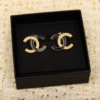 55880B6D-E292-074B-8311-05C14974916B.png CCE444 CC Black enamel gold embossed stud earrings